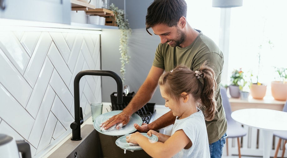 Father and daughter doing the washing up 