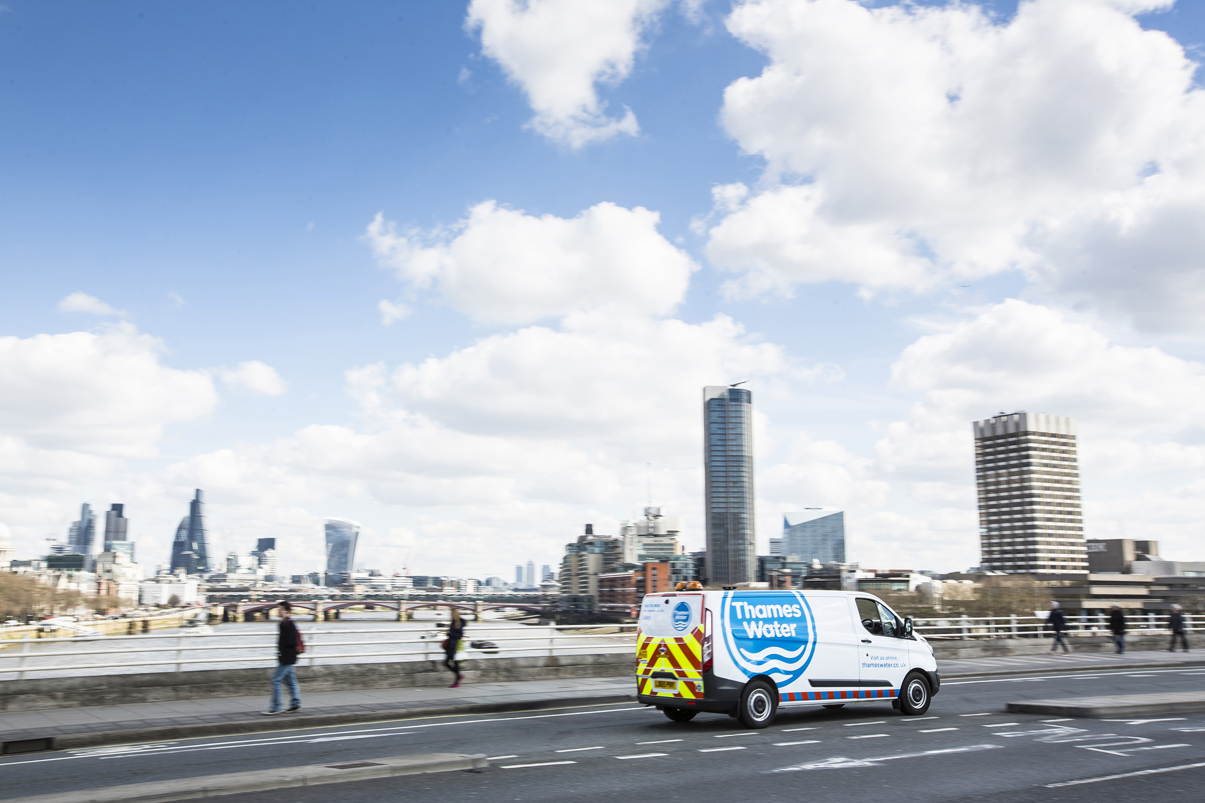 A Thames Water Van drives over a bridge in central London