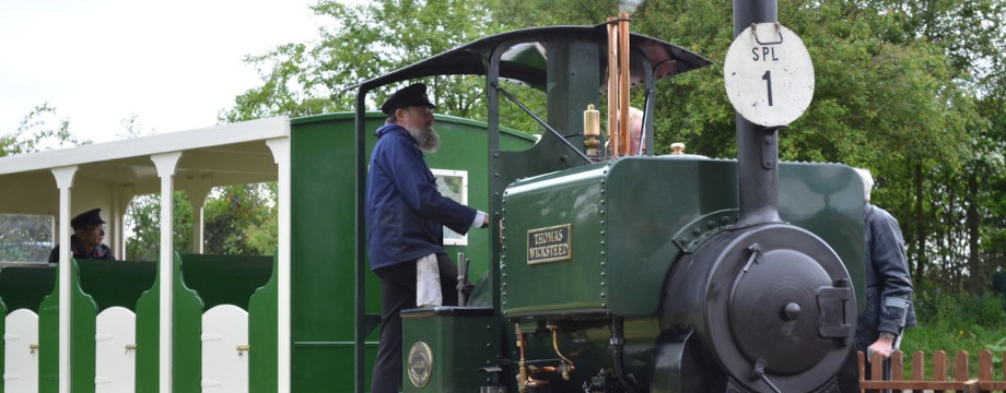 Man operating an old steam train