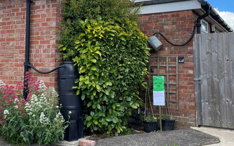 Image showing a water butt connected to drainage pipes on the side of a house