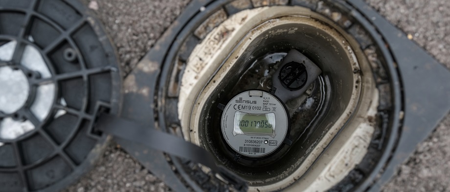 A digital water meter outside a customer home