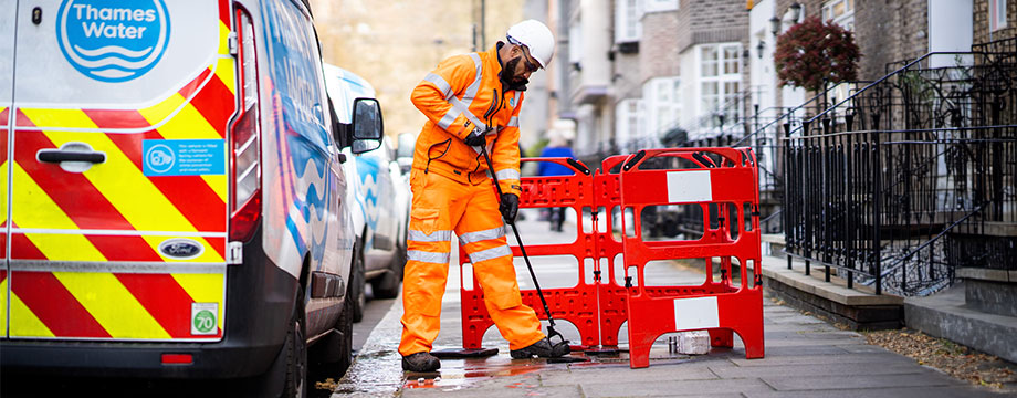 A Thames Water workman holding a meter