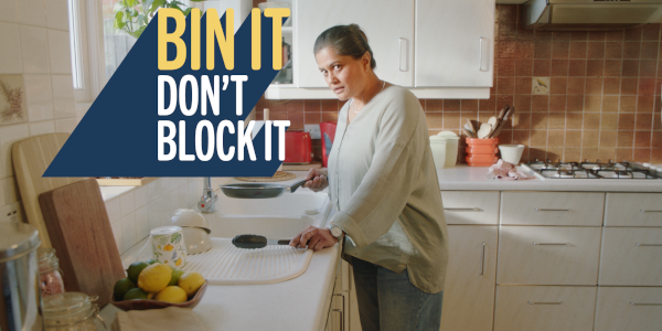 Woman not pouring cooking oil down the drain, to avoid causing blocked pipes