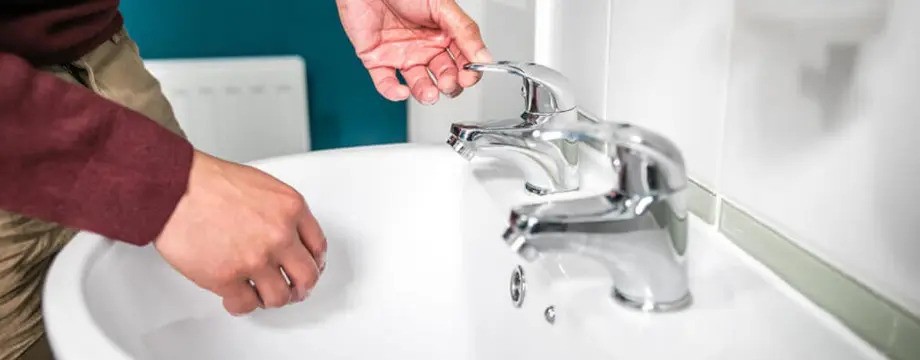 Man washing his hands at the sink