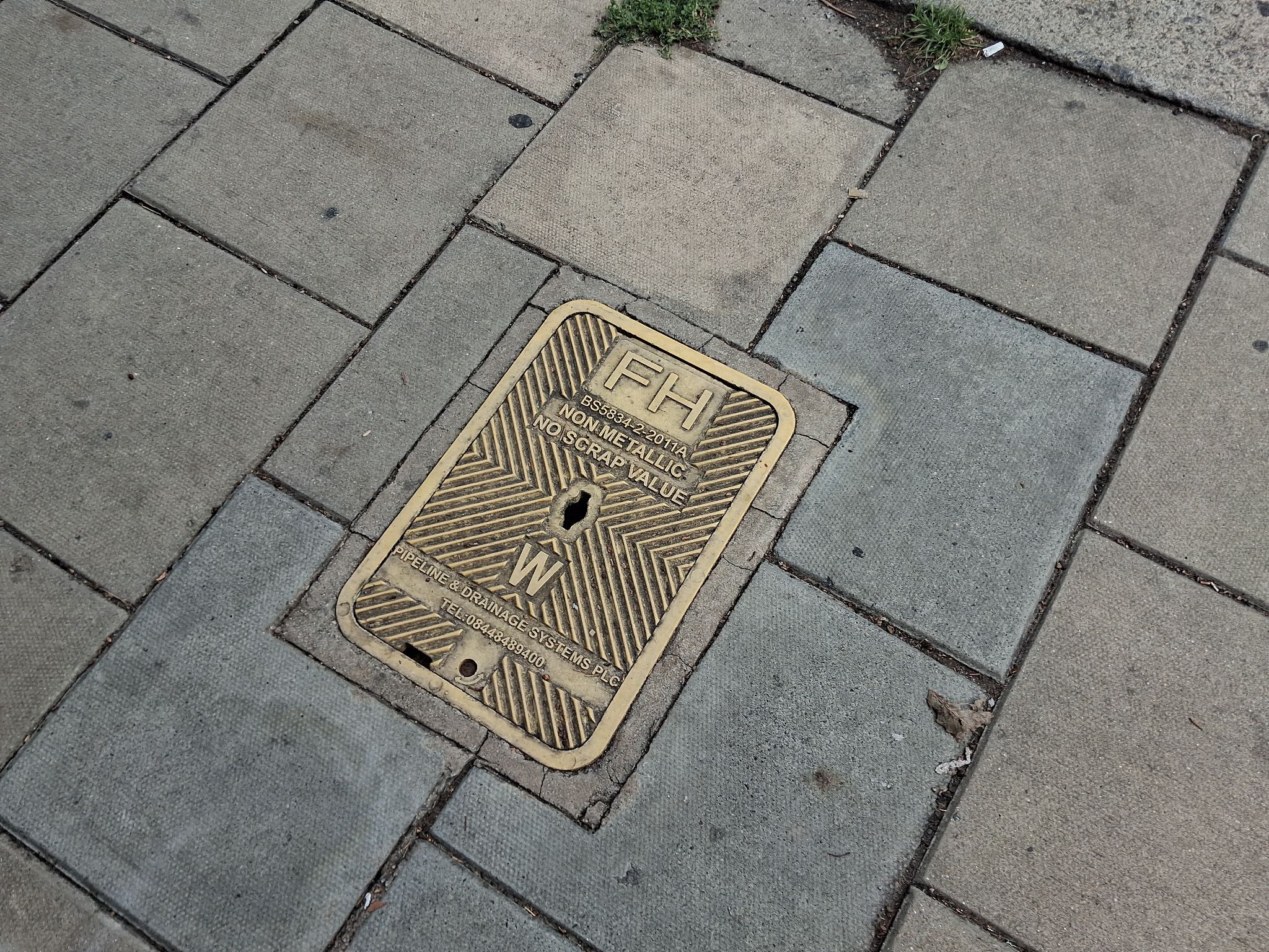 A picture showing a non metallic yellow fire hydrant