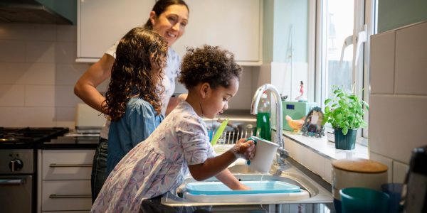 Family at kitchen sink