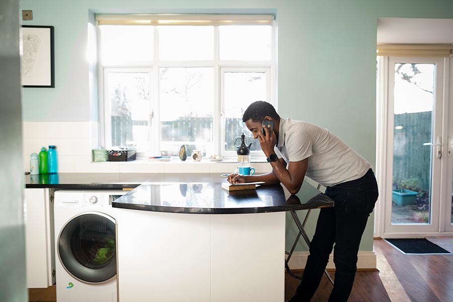 Man speaking on the phone in the kitchen