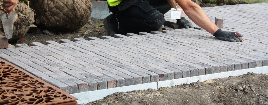 bricks being laid near a water drain