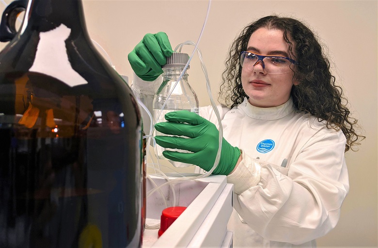 An apprentice water analyst working in the lab