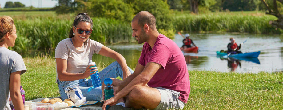 Friends having a picnic by a river