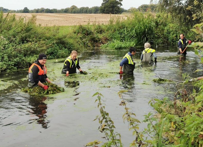 Removing weeds from Roundmoor Watercourse in Slough