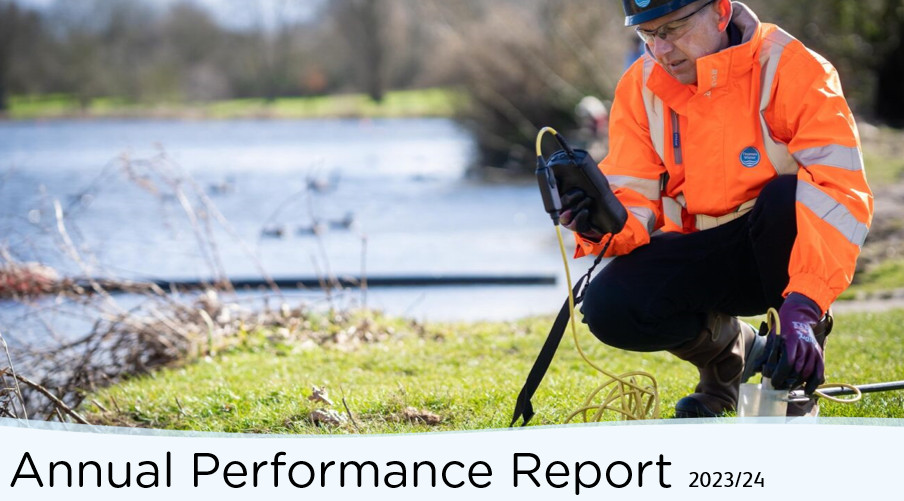 Annual performance report cover with engineer testing water quality
