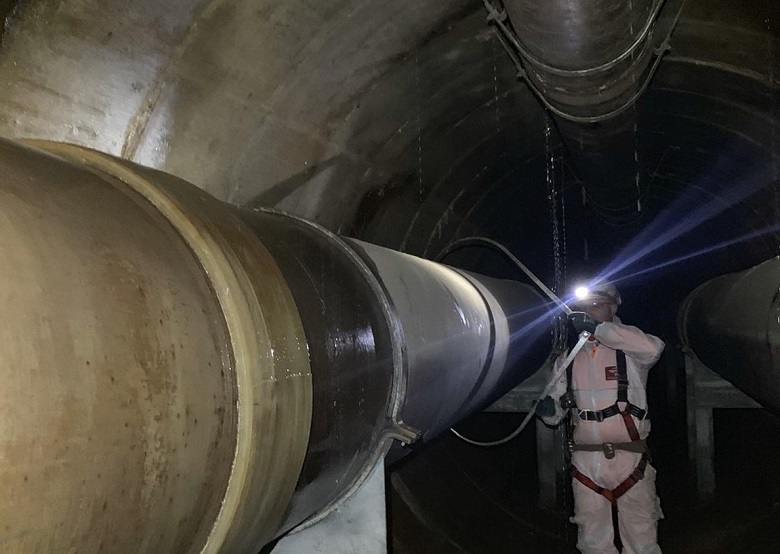 An engineer taking a look at the pipe under Battersea Power Station