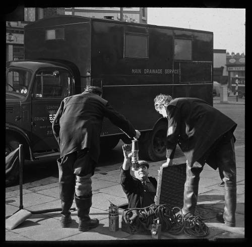 Black and white image of engineers at work
