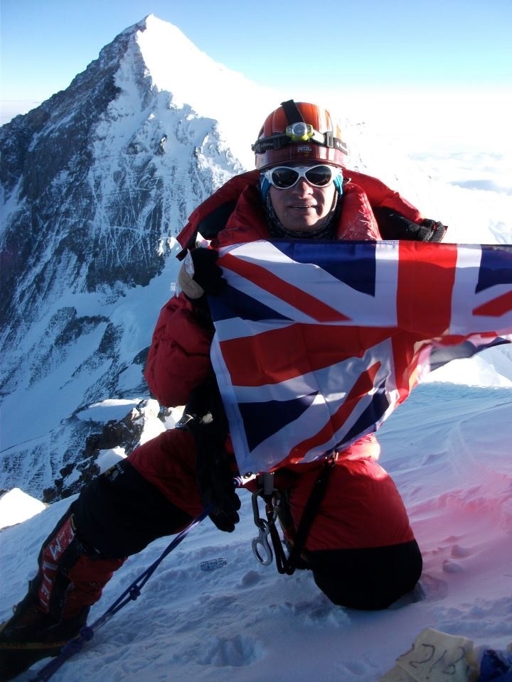 Alex on the summit of Lhotse holding a Union Jack flag