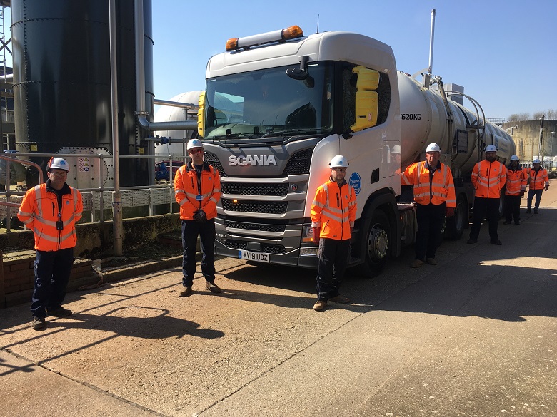 Truck drivers standing around a truck on a Thames Water site