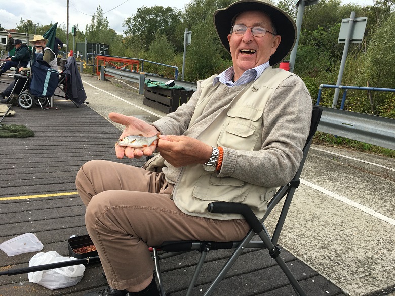 A Chelsea Pensioner catches a fish at Walthamstow Wetlands