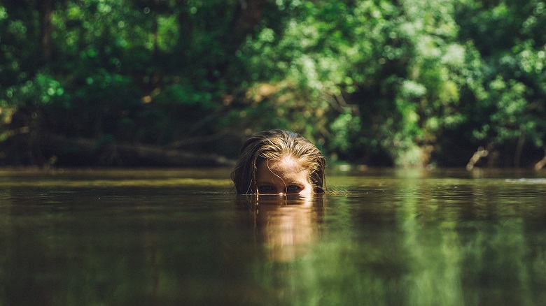 Woman swimming in a river