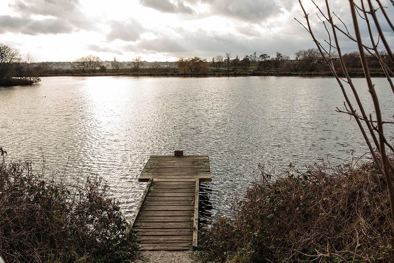 A wooden jetty sits on top of a lake