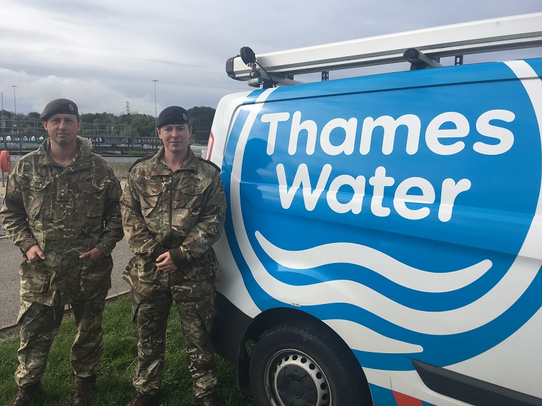 Two soldiers next to a Thames Water van