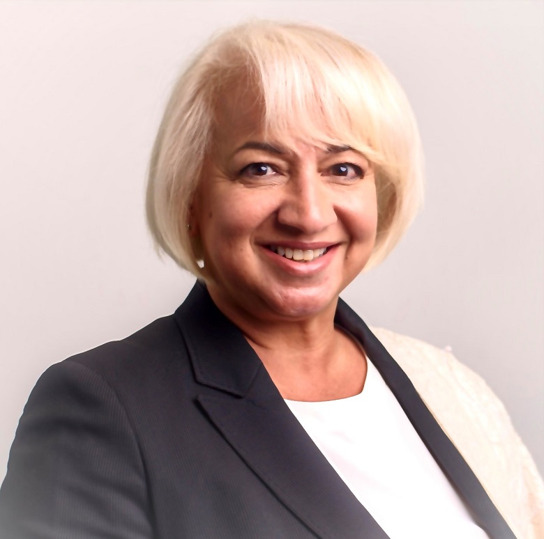 A woman with blonde hair wearing a black and white jacket