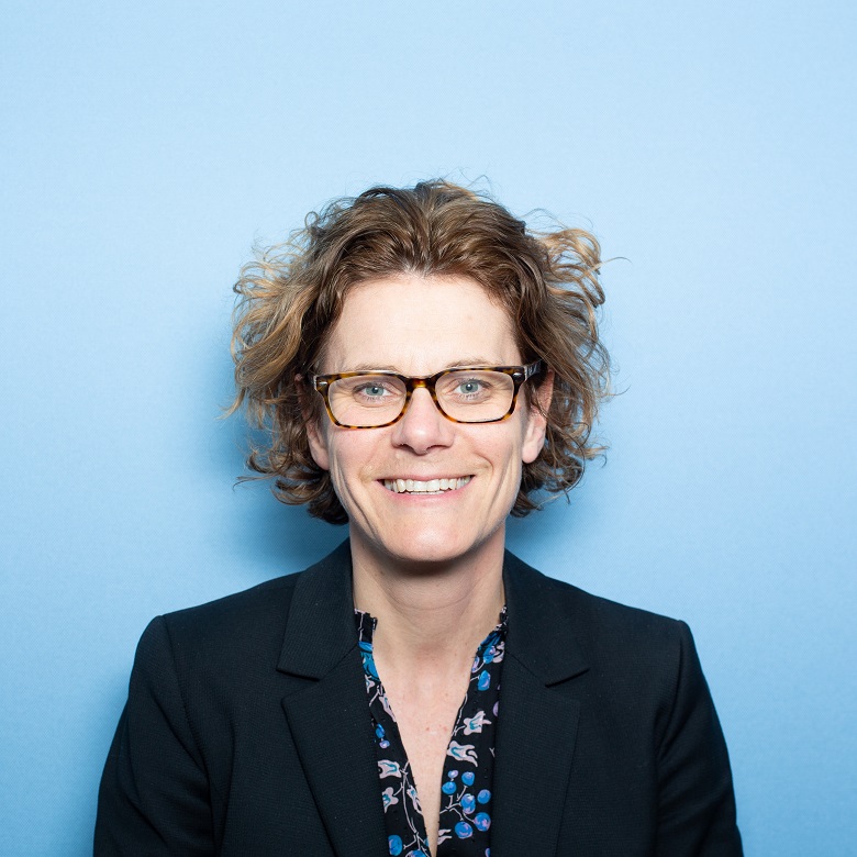 A woman with brown hair and glasses