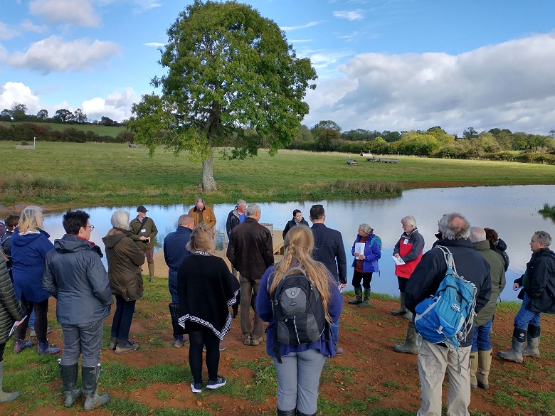 Guests gather round a new wetlands at the River Evenlode event