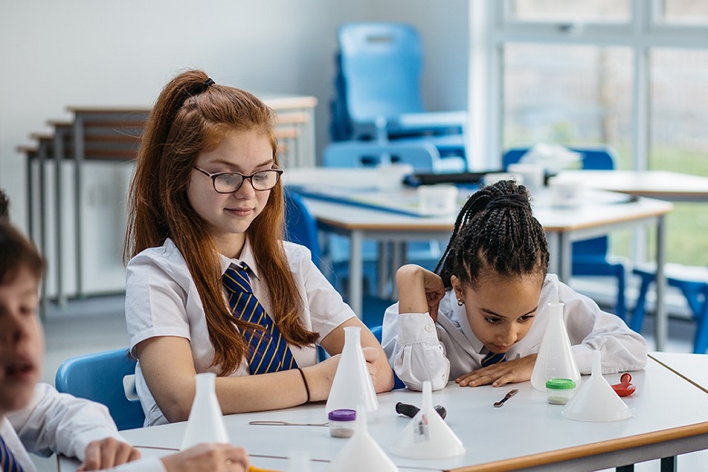 Two school children take part in a water experiment