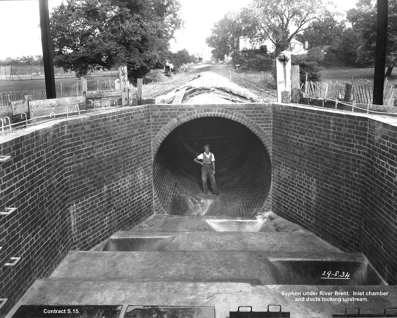 A man stands in a network tunnel at Mogden sewage works