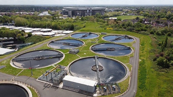 Aerial view across Mogden sewage treatment works looking at settlement tanks