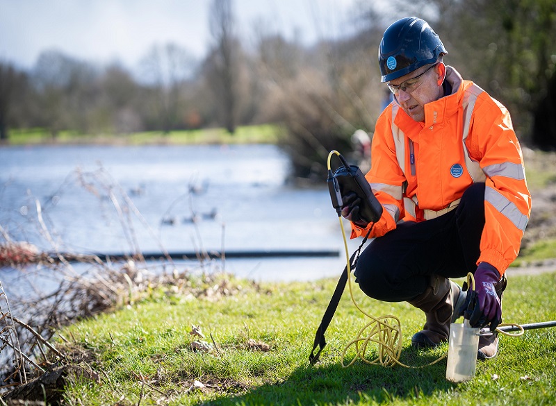 A Thames Water engineer taking samples from a river for testing