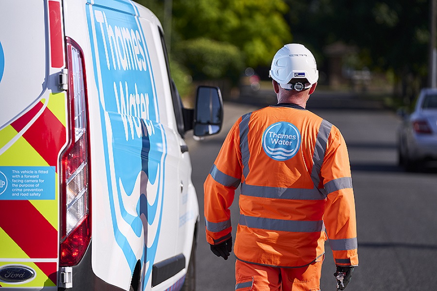 A Thames Water engineer standing next to a Thames Water van
