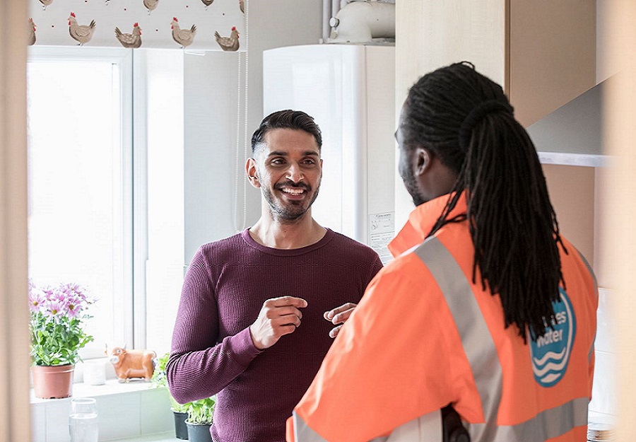 A Thames Water employee visits a customer in their home