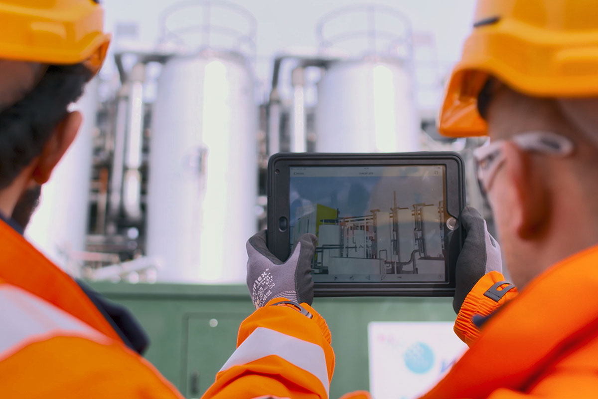 A picture of two engineers using a tablet at a Thames Water site