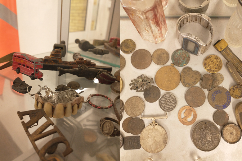 A cabinet showing dentures, money and a red toy bus