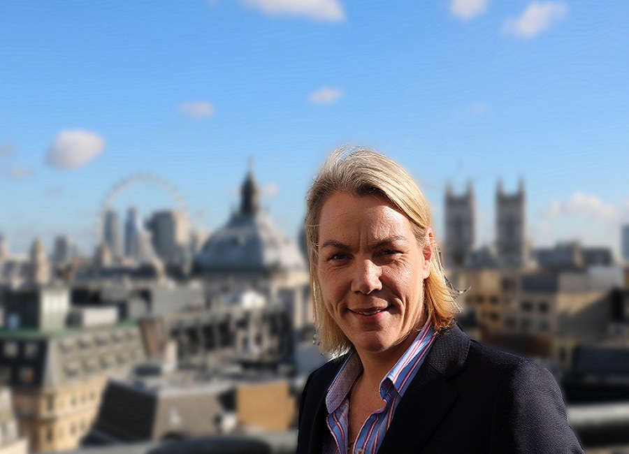 Esther Sharples headshot in front of London skyline