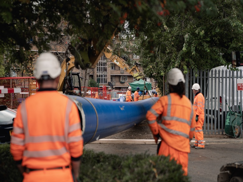 Workers in PPE with the new pipework