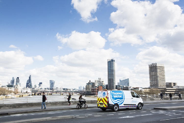 A Thames Water van driving over a bridge in London