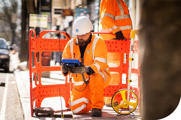 A Thames worker checks usage by a manhole cover
