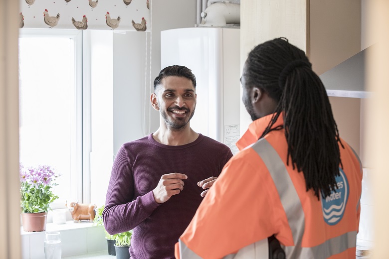 A Thames Water employee visiting a customer at their home