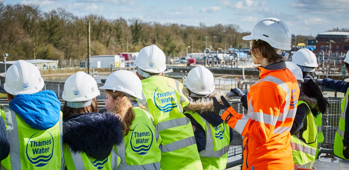 Thames Water employee leading a site visit with school children