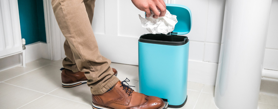 Person putting wet wipe in the bin