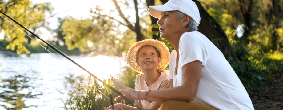 Family members fishing by a river