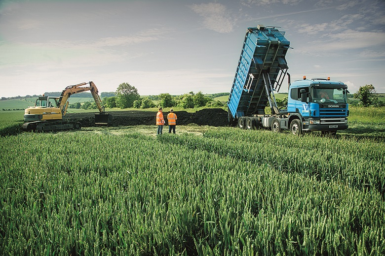 Photograph of a large truck in a field