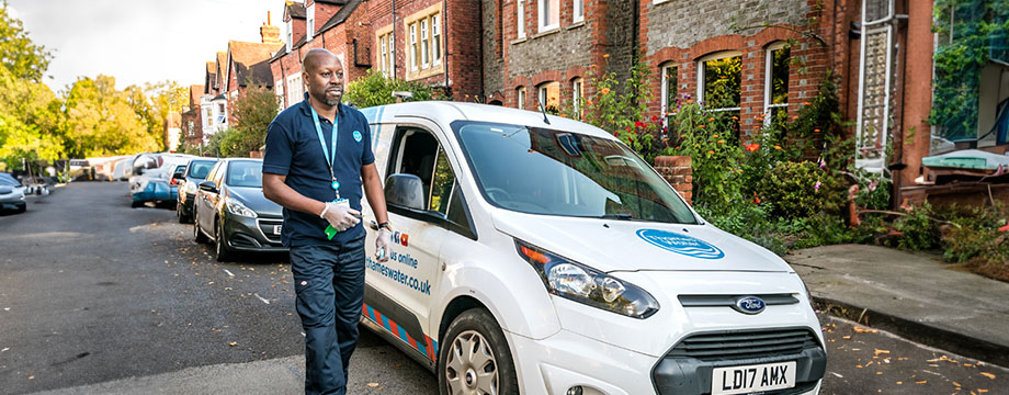 A Thames worker leaves gets out of their van in the street