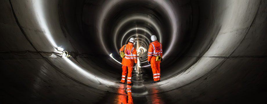 Thames workers inspect a large tunnel