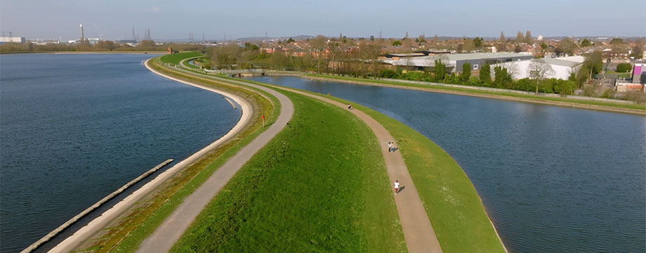 A strip of land with a path between two large bodies of water