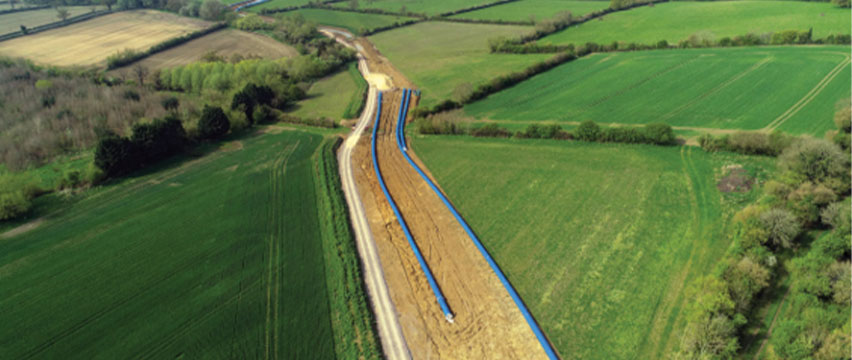 An aerial view of a large pipe in a field