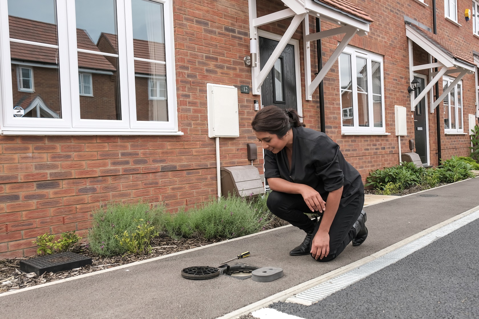 Customer opens cover to read their water meter