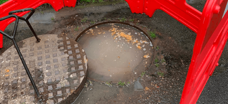 Manhole flooded with sewage